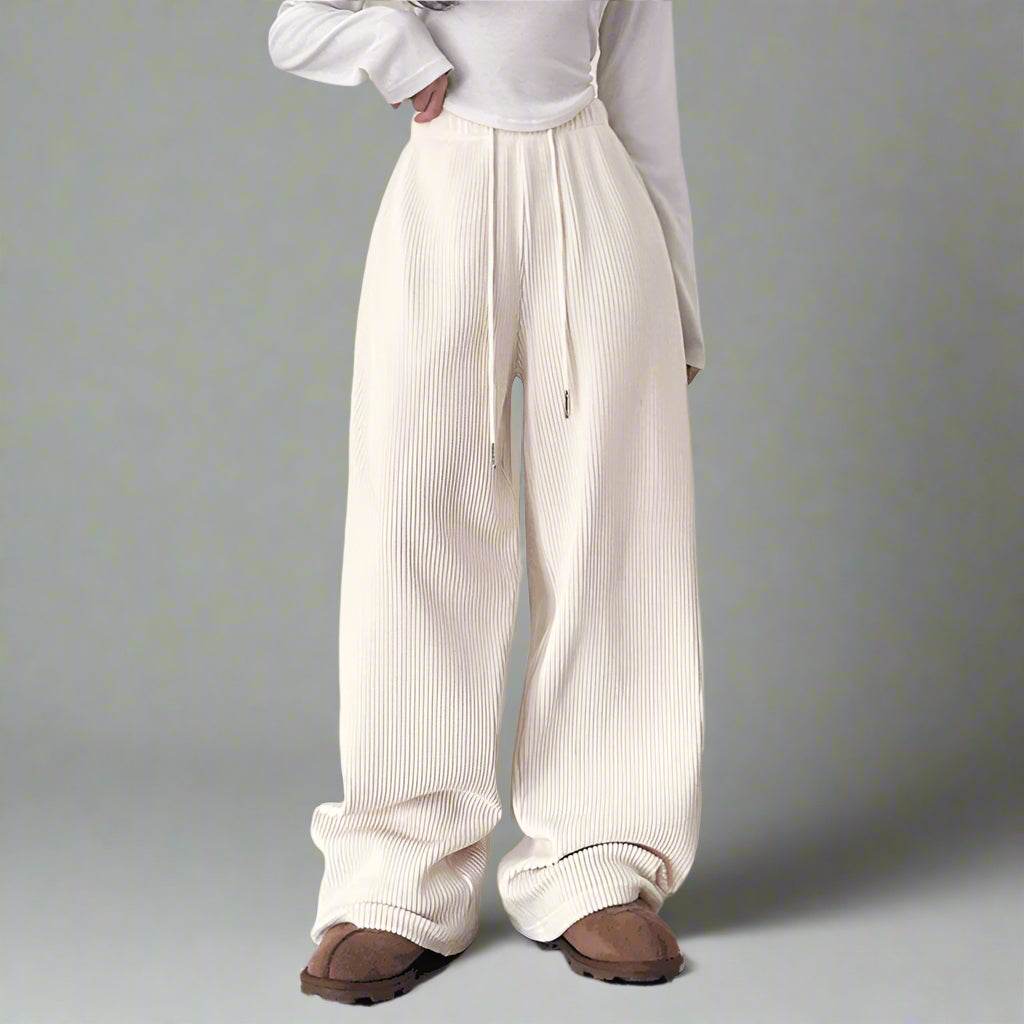 a girl wearing a white lace up pants