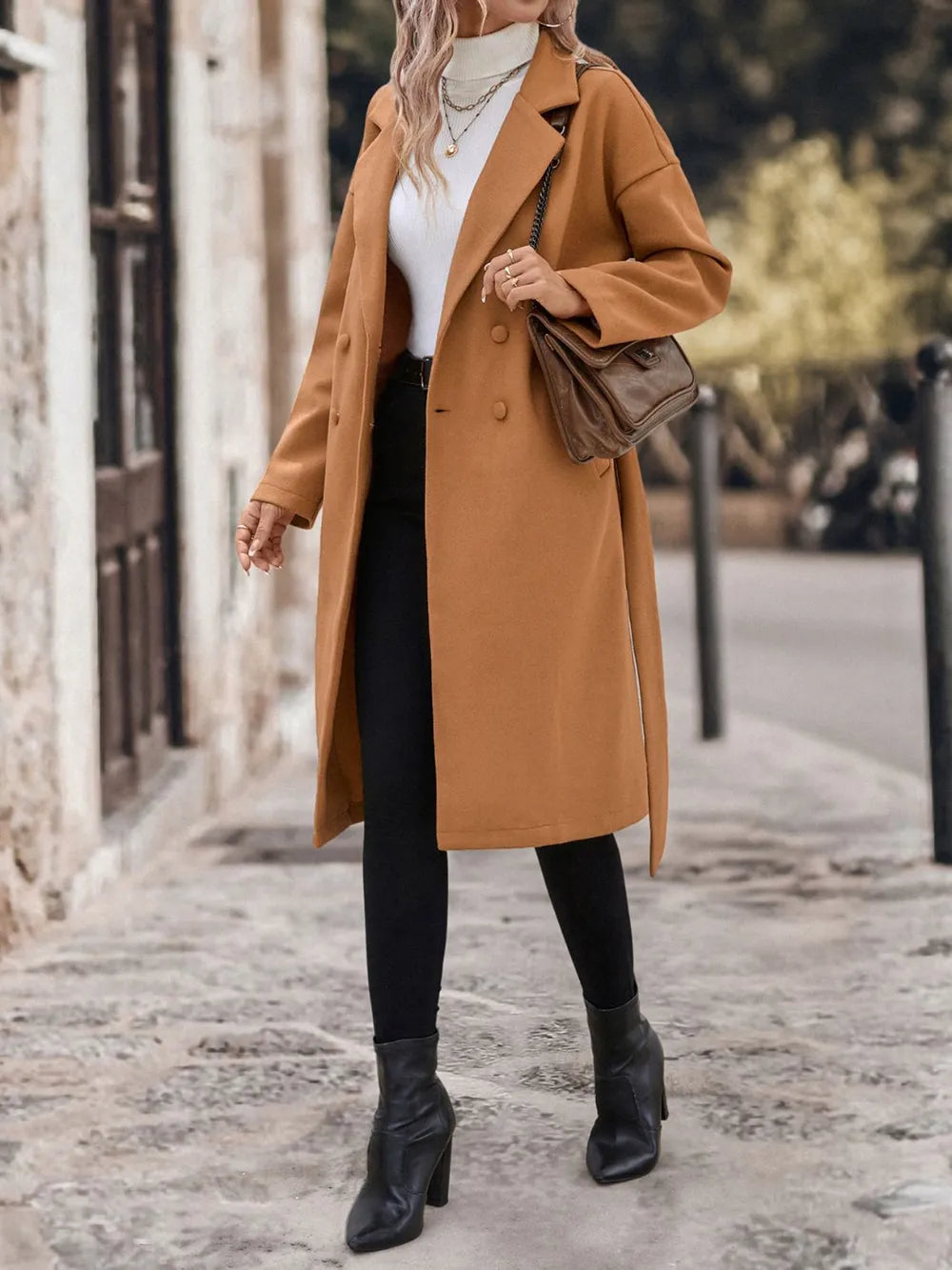A woman wearing a caramel coat