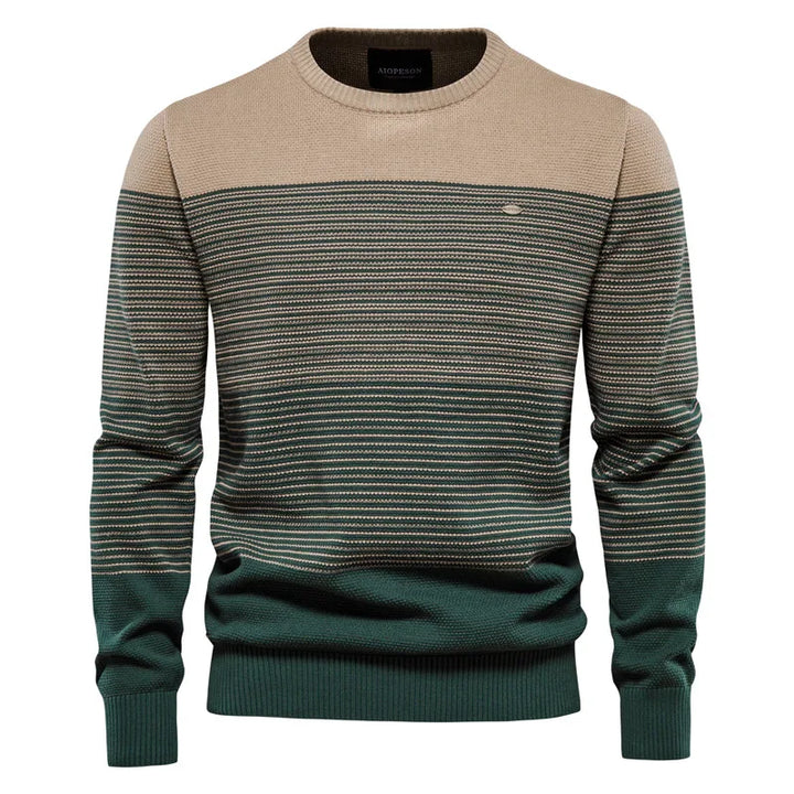 Two-tone sweater with beige and green pattern on a white background
