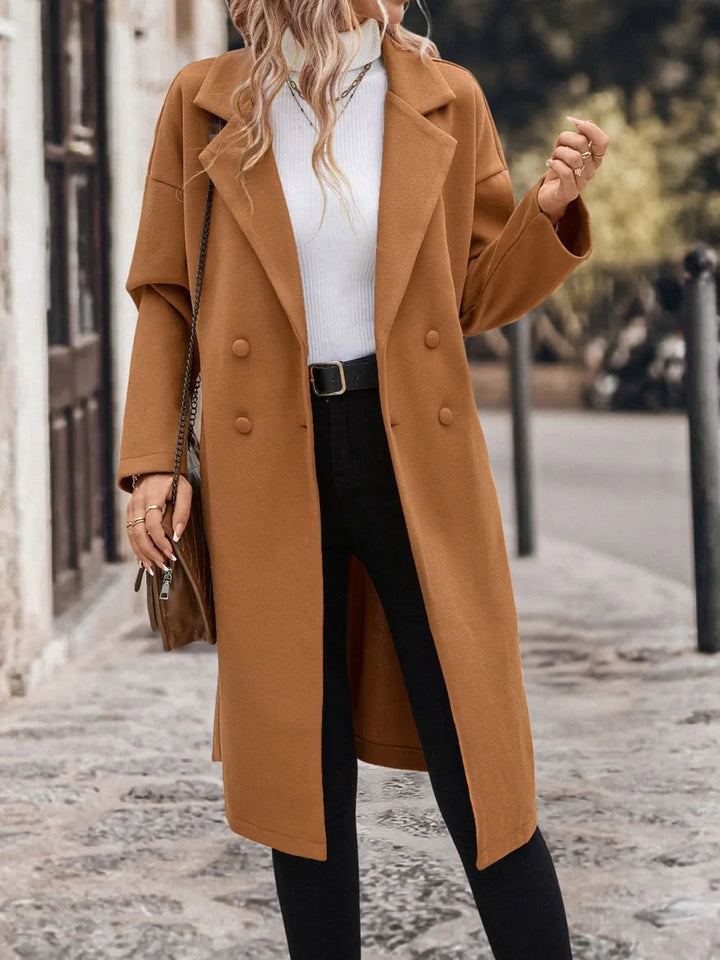 A woman wearing a caramel coat
