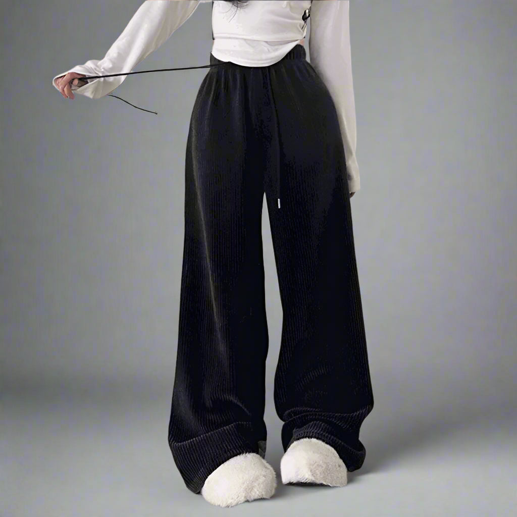 a girl wearing a black lace up pants