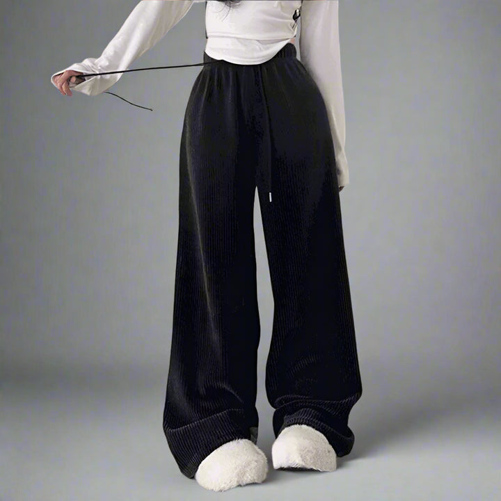 a girl wearing a black lace up pants