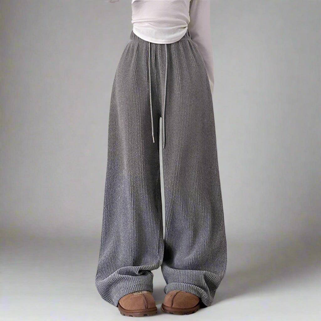 Gray wide-leg pants worn by a person on a plain background