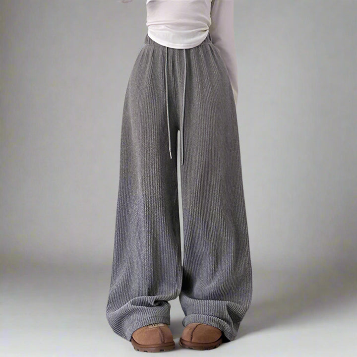 Gray wide-leg pants worn by a person on a plain background