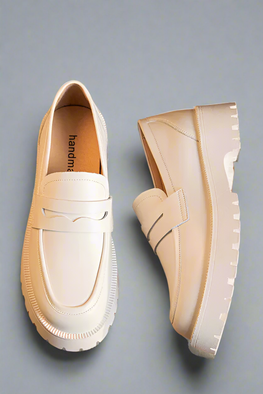 White loafers on a wooden surface