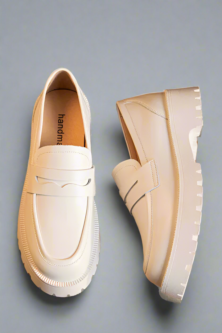 White loafers on a wooden surface