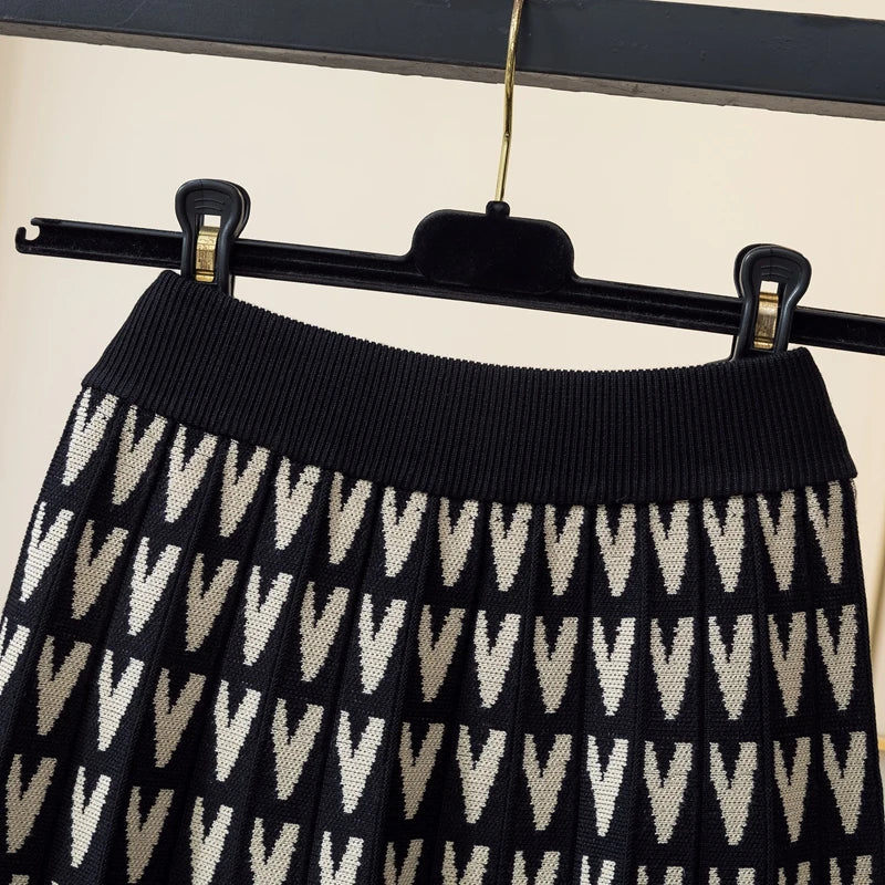 Black and white patterned skirt on a hanger against a neutral background