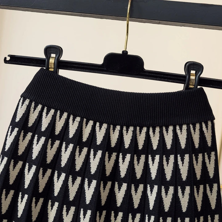 Black and white patterned skirt on a hanger against a neutral background