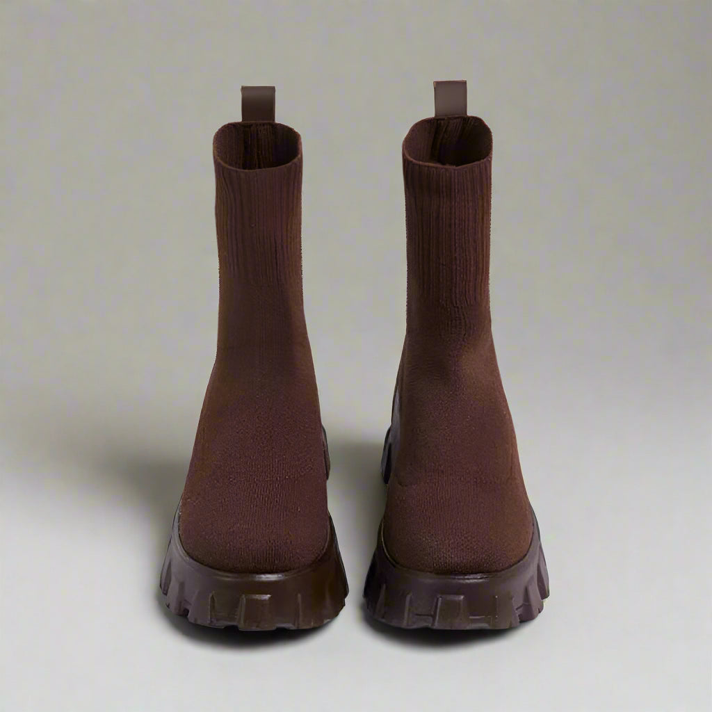 Pair of brown ankle boots on a white background