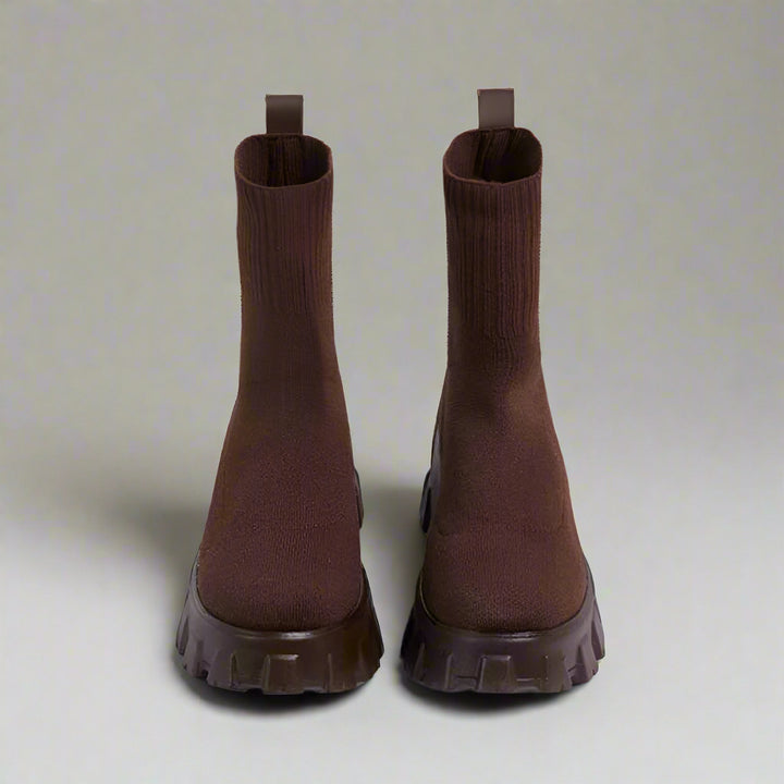 Pair of brown ankle boots on a white background