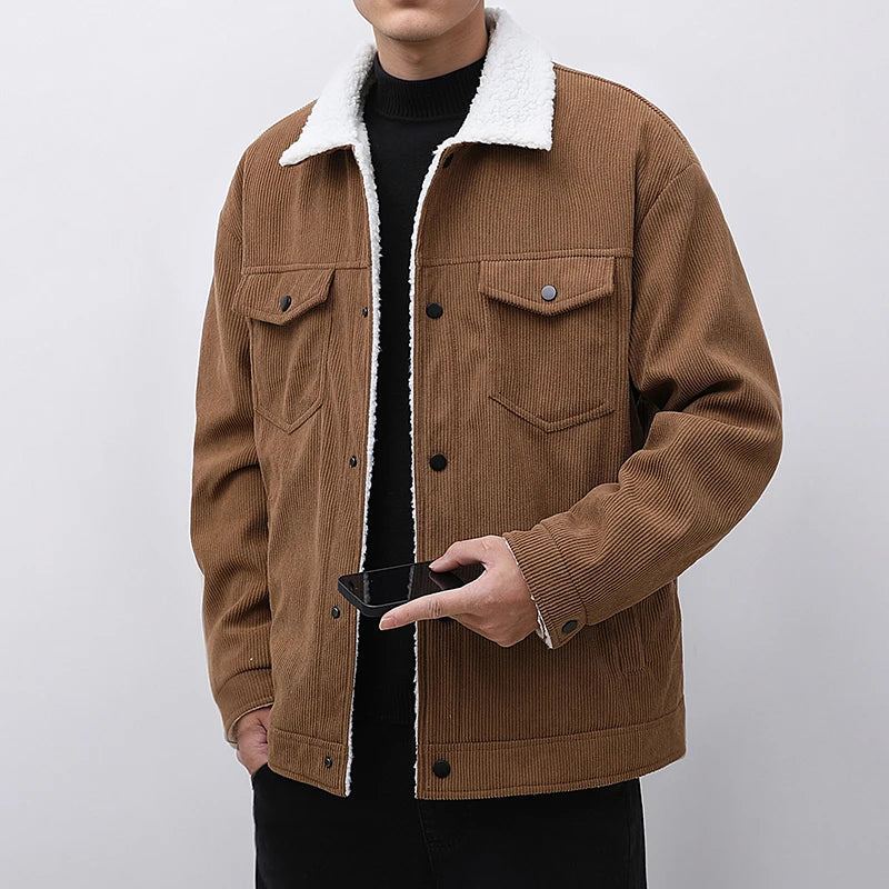 Brown corduroy jacket with white sherpa lining worn by a person on a plain background