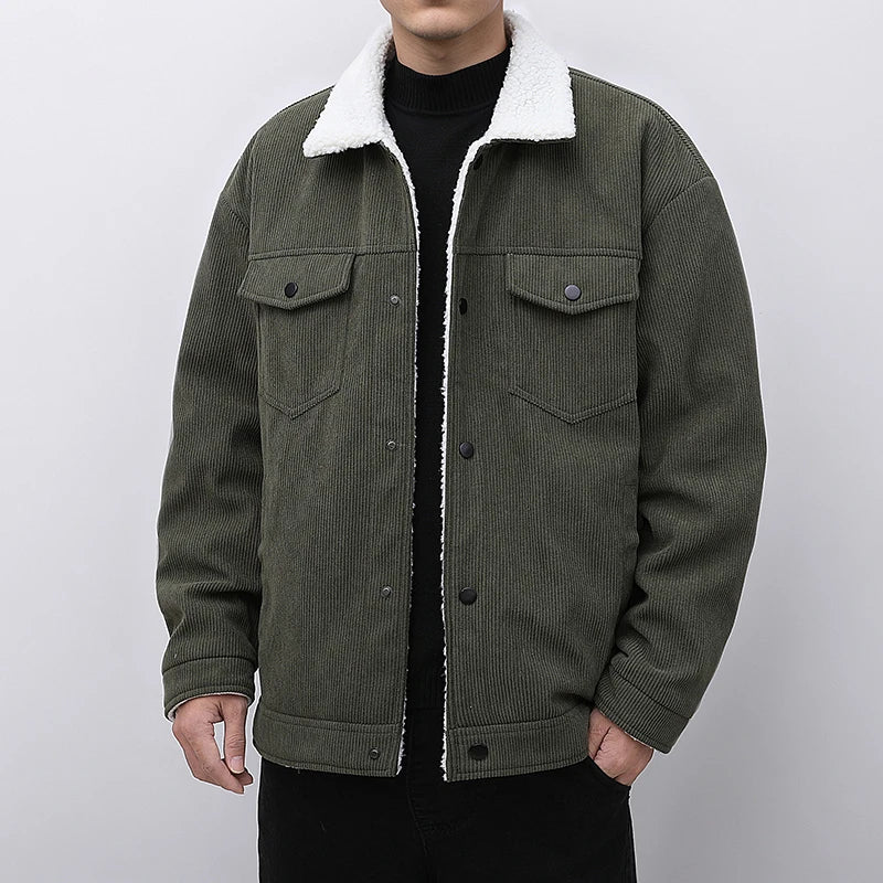 Green corduroy jacket with white sherpa lining on a plain background