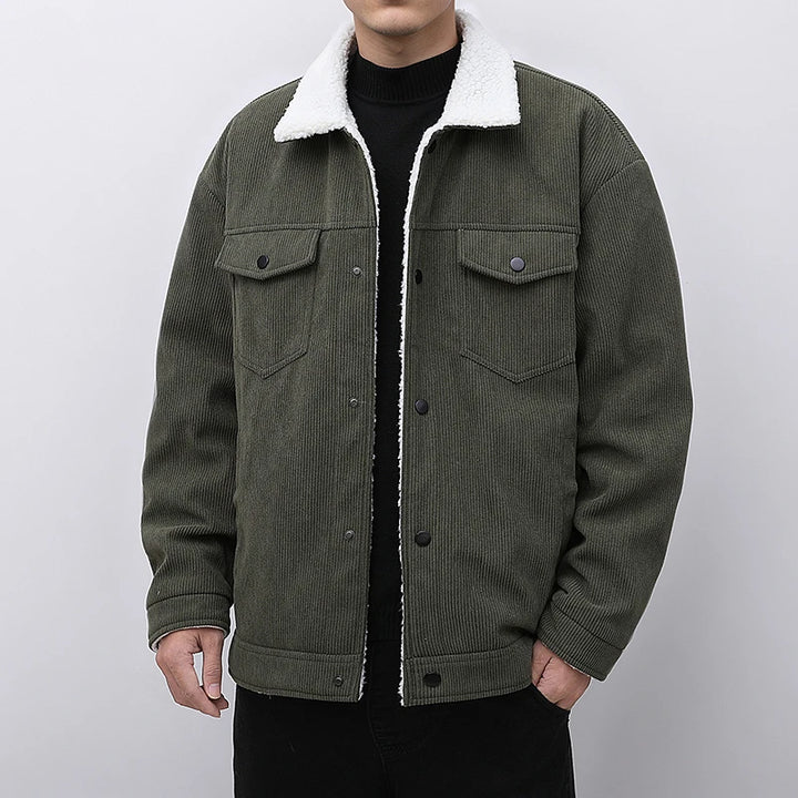 Green corduroy jacket with white sherpa lining on a plain background