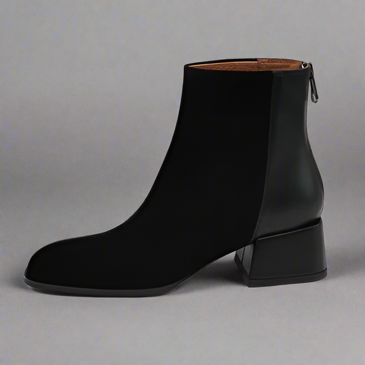 Black ankle boot on a gray background